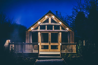 Facade of illuminated house at night