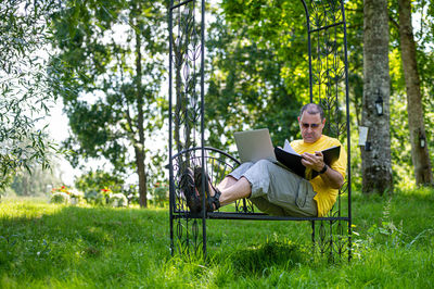 Young man sitting on field