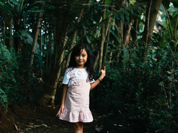 Portrait of a smiling young woman in forest