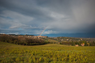 Beautiful rainbow over chianciano terme medieval village in tuscany