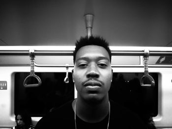 Portrait of young man sitting in bus