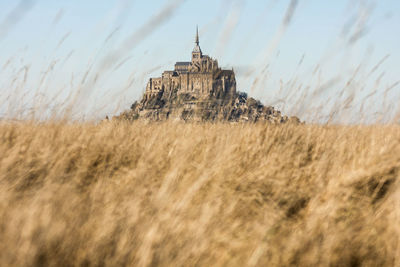 Mont saint  michel on field against sky