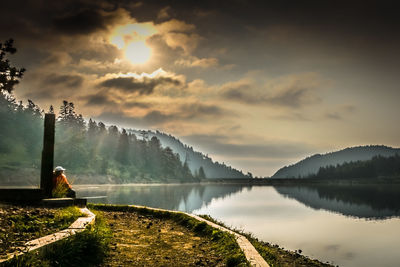 Scenic view of lake against cloudy sky