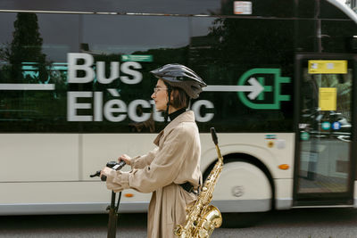 Side view of woman standing on street