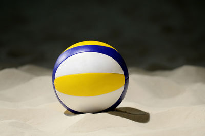 Close-up of yellow ball on sand