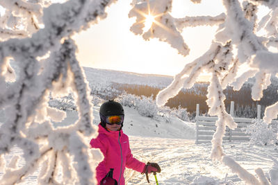 Rear view of woman standing on snow