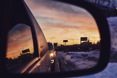 Cars on road at sunset