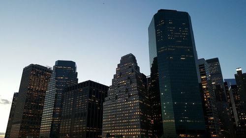 Low angle view of buildings against clear sky at night