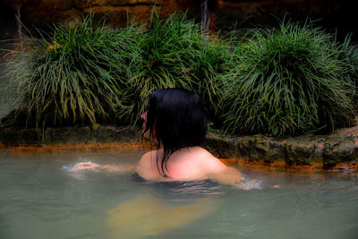 Rear view of woman in swimming pool
