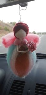 Close-up of stuffed toy hanging from car window