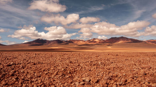 Scenic view of arid landscape against sky