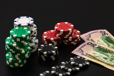 Close-up of coins on table against black background