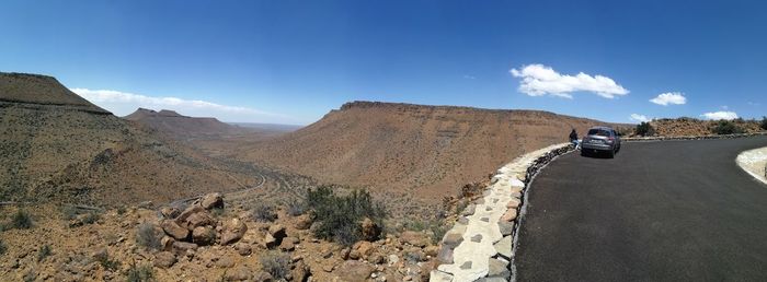 Panoramic shot of car on road against mountain range