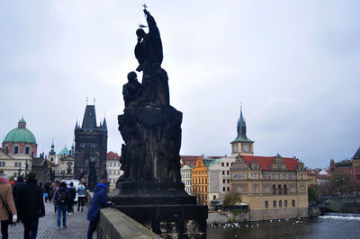 Statue of buildings against cloudy sky