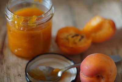 Close-up of abricot marmelade in glass jar on table