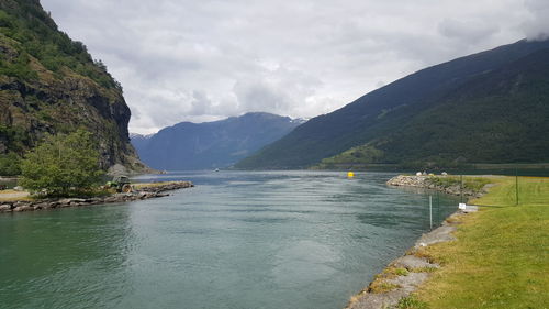 Scenic view of mountains against cloudy sky