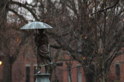 Close-up of statue against bare trees