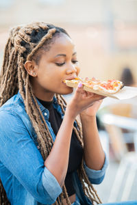 Midsection of woman eating ice cream