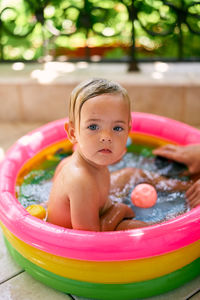 Portrait of cute boy in swimming pool