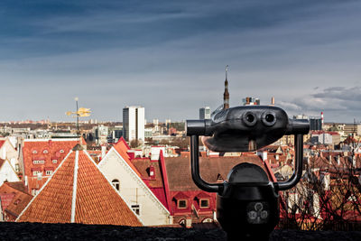 Coin-operated binocular against cityscape