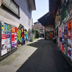 Graffiti on street amidst buildings in city