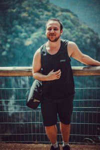 Portrait of smiling young man standing outdoors