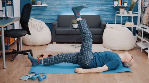 Woman lying on sofa at home