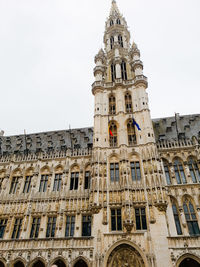 Low angle view of clock tower against sky in city