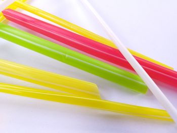 High angle view of multi colored pencils on white background