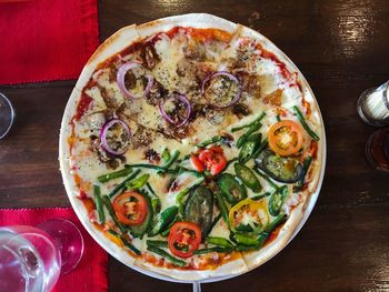 High angle view of pizza served on table