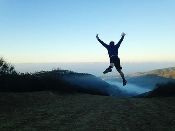 Full length of woman jumping in mid-air