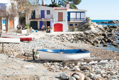 Fisherman vilage with small corful houses on costa brava coast, boats in sea. 