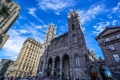 Low angle view of buildings in city against sky