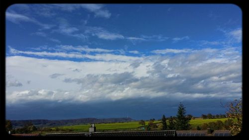 Scenic view of landscape against cloudy sky