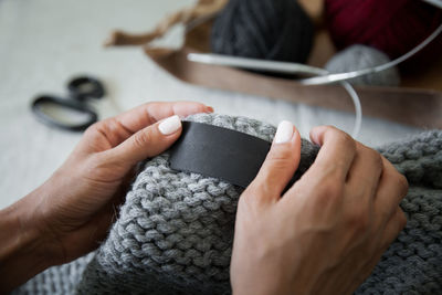 Cropped hands of woman using mobile phone