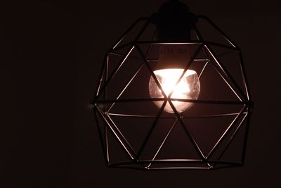 Close-up of illuminated lamp against black background