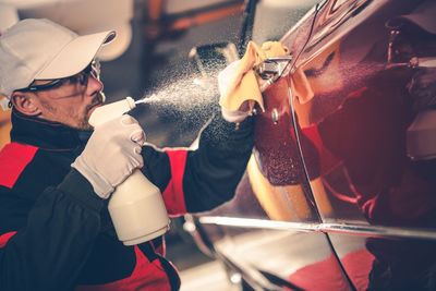 Man washing car at garage