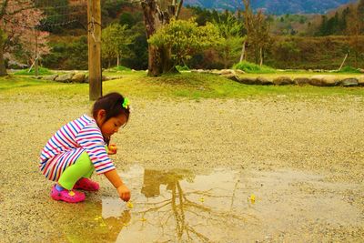 Side view of baby girl on land