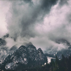 Low angle view of snowcapped mountains against sky