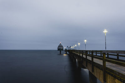 Pier over sea against sky