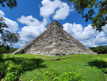 Mayan temple ruin against cloudy sky 