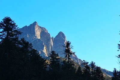 Scenic view of mountains against clear blue sky