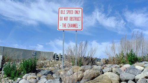 Road sign against sky