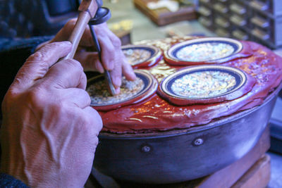 Cropped hands of man working at workshop