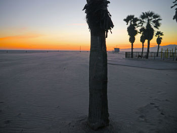 Scenic view of beach against sky during sunset