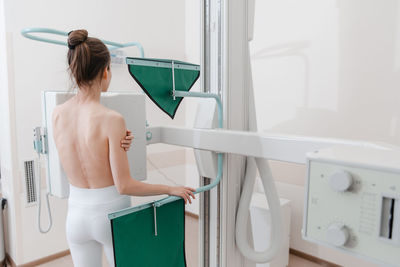 Shirtless woman scanning chest at clinic