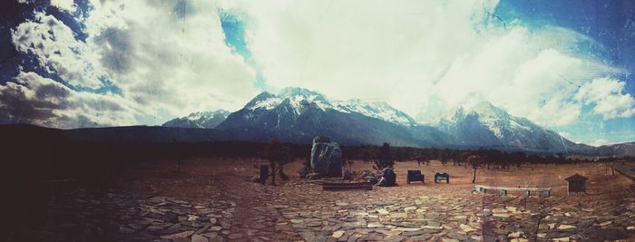 Mountain range against cloudy sky