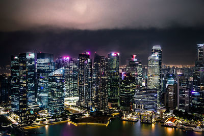 Illuminated buildings against sky at night, singapore 