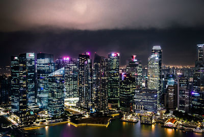 Illuminated buildings against sky at night