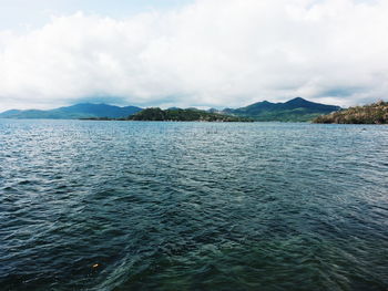 Scenic view of sea against cloudy sky